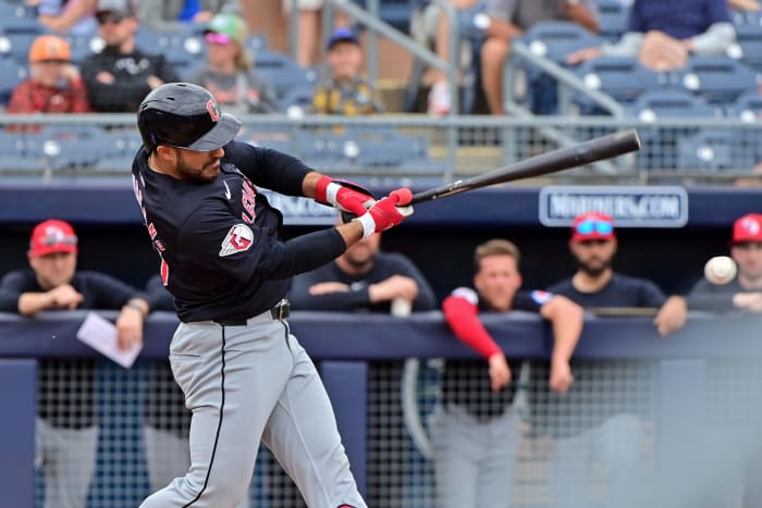 Feb 26, 2024; Peoria, Arizona, USA; Cleveland Guardians right fielder Ramon Laureano (10) singles in the first inning against the San Diego Padres during a spring training game at Peoria Sports Complex.